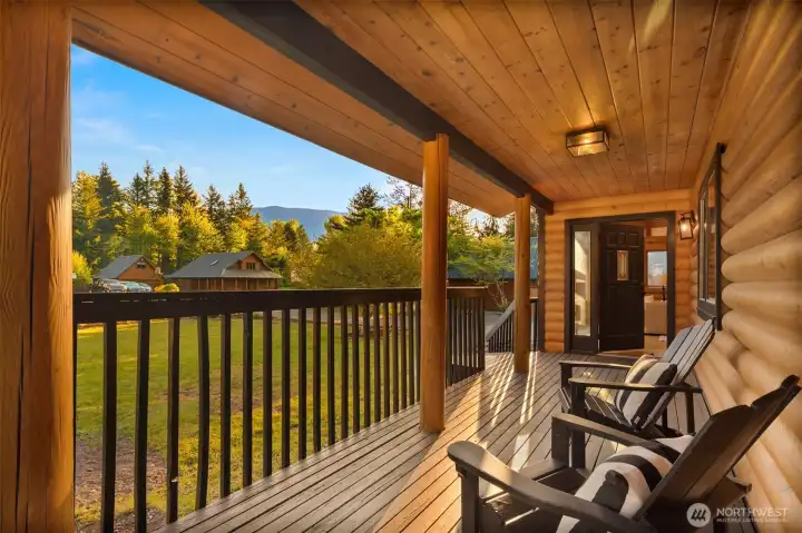 Expansive, covered front porch .overlooking the manicured front yard.