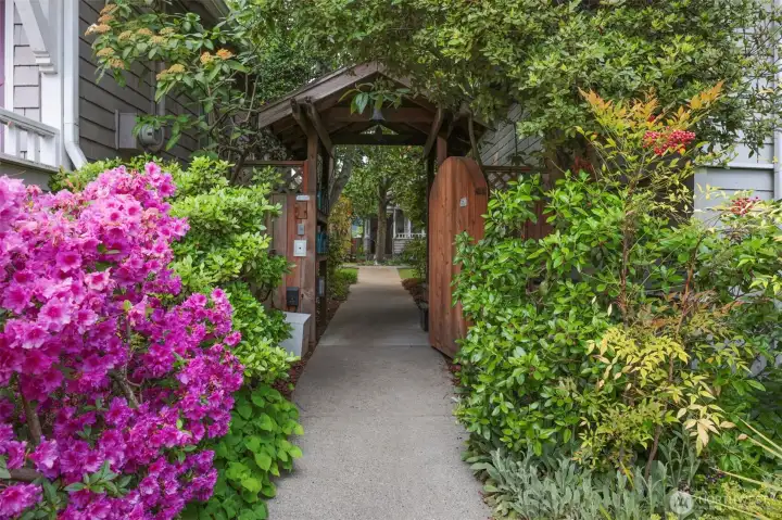 Come home to a secret garden setting every day! This coded gate accesses the path through the courtyard to the lovely cottage.