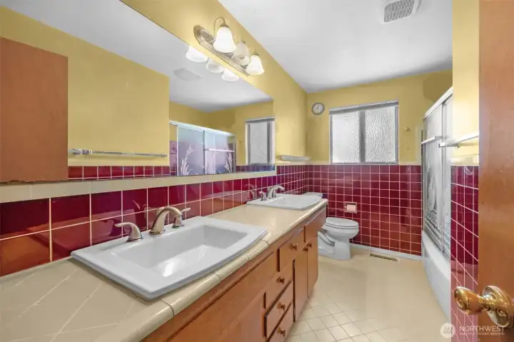 The upstairs bathroom has a shower/tub and dual sinks