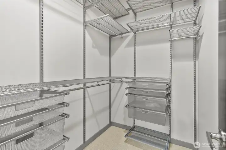 Primary bedroom closet with custom shelving Primary bedroom closet with custom shelving