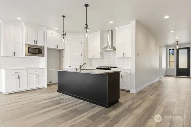 Kitchen with corner walk in pantry. Photo not of actual home. Colors and finishes may very.