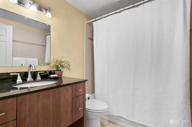 Primary bathroom with bathtub and shower.