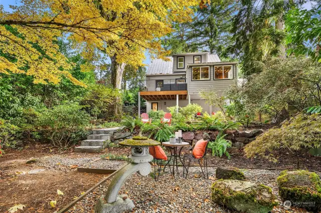 Beautiful terraced garden with rock retainer wall and mature plants/trees