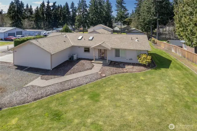 House has an attached garage. The 3-bay shop is beyond the house.