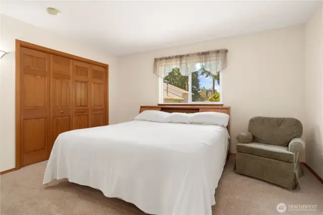 The spacious main bedroom features double closets with solid core doors.