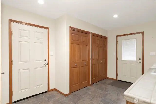 The opposite side of the laundry room has a door leading to the attached garage.