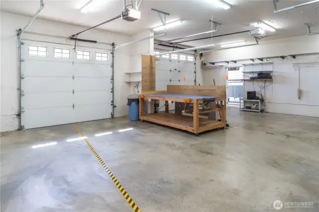 Large well-kept shop has built-in sound system. The 9' garage doors has a matching door on the opposite side so that you can drive through. The 14' RV garage is beyond the door by the stereo system.
