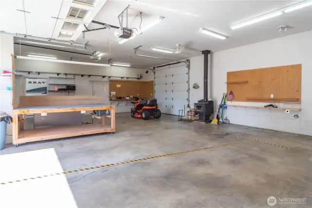 Wood stove keeps the shop cozy in the winter. There is a peg board system on the far wall.