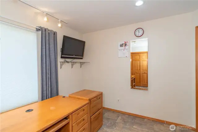 The mirror on the office wall conceals an ironing board.