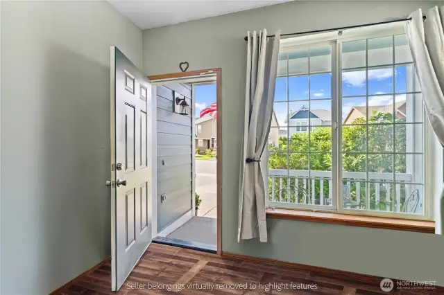 Bright entry room with large windows and view to front porch