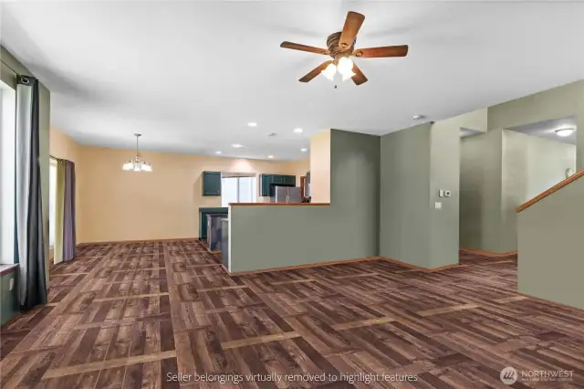 Open concept layout connecting kitchen, dining, and living areas