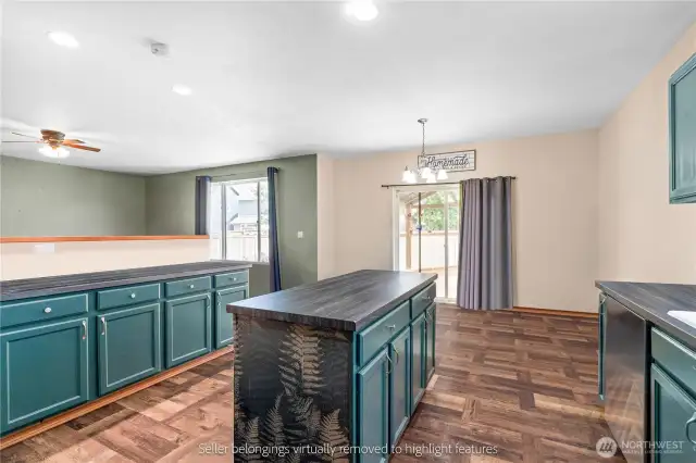 Kitchen dining area with sliding door access to backyard patio and ample natural light