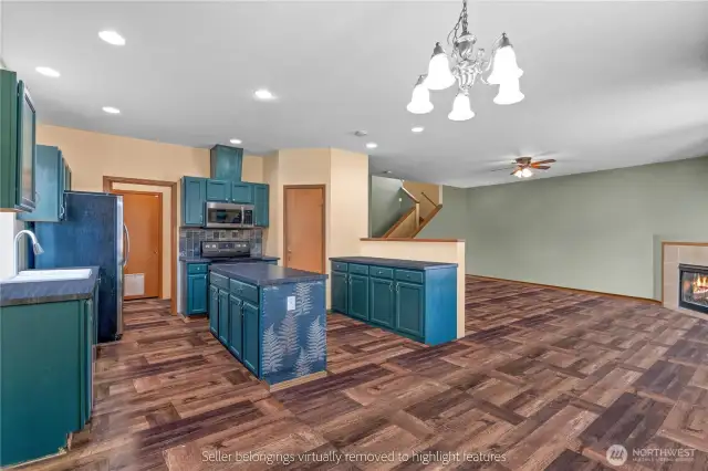 Updated kitchen with teal cabinets, newer stainless steel appliances, and walk-in pantry