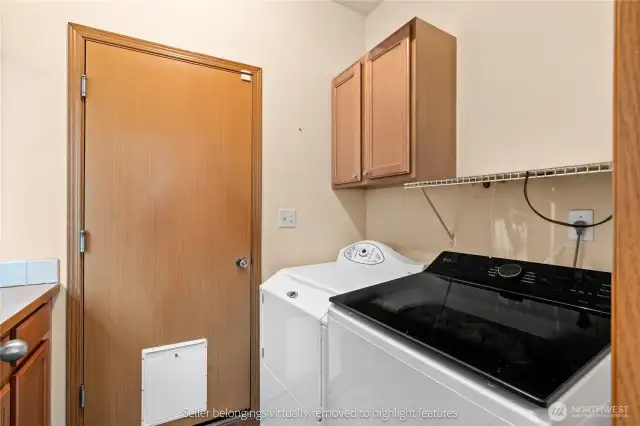 Laundry room with included washer, dryer, and built-in storage cabinets