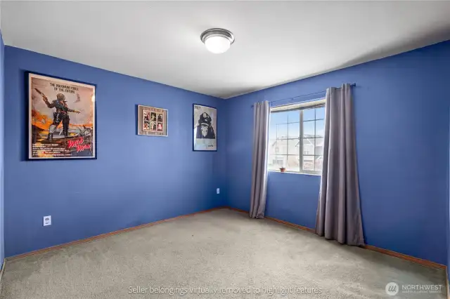 First bedroom with blue walls and good natural light
