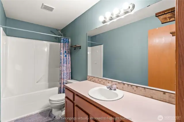 Full bathroom with tub/shower combo and decorative tile