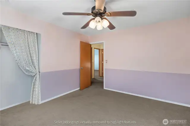 Alternate view of third bedroom with ceiling fan highlighting natural light and comfort