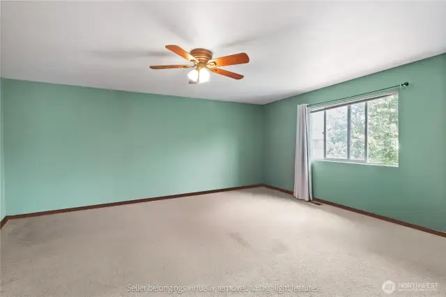 Primary bedroom showing generous size and natural lighting