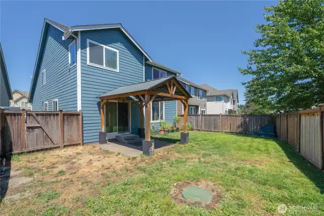 Rear yard view with gazebo and fully fenced yard