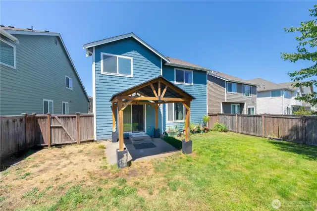 Back exterior showing siding, gazebo, and private yard space