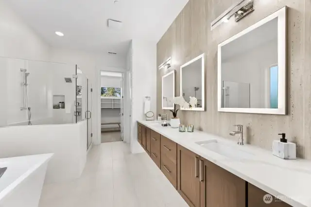 Spa bath with heated floors, extensive tile, walk in shower, and soaking tub.