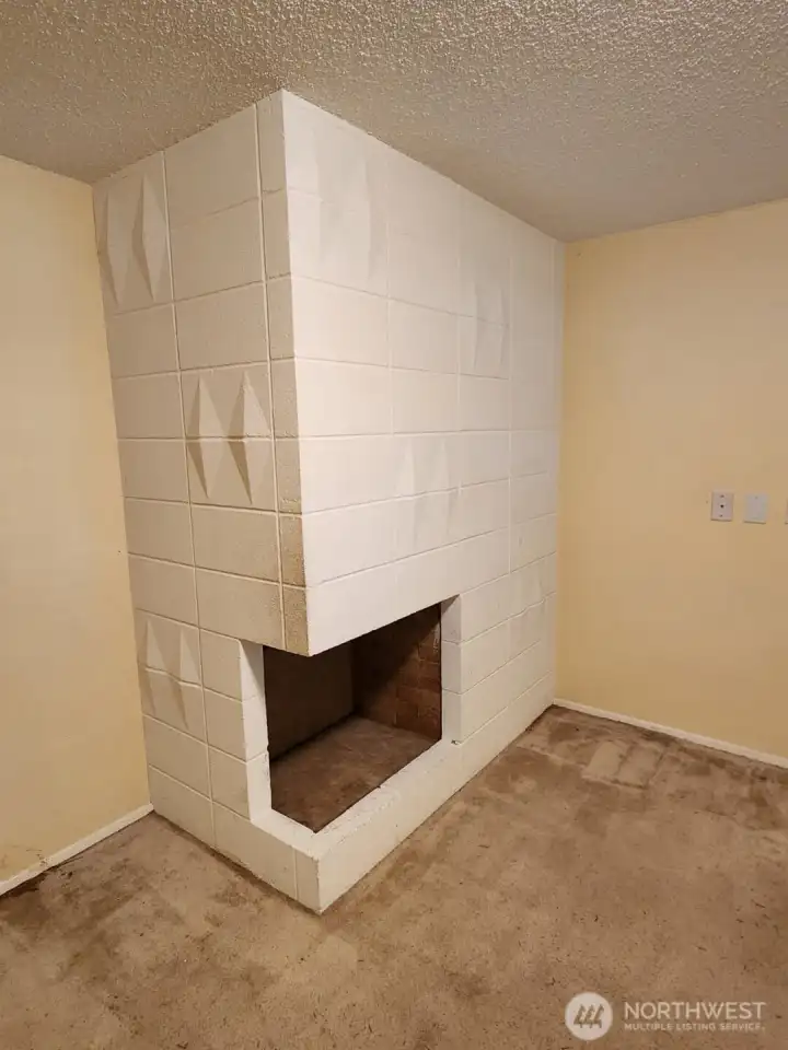 with the coolest fireplace, this room would make a perfect office or flex room