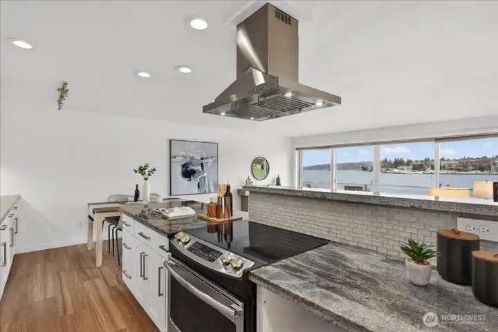 Open, well-designed kitchen with island seating and generous counter space, positioned to capture views of Lake Washington