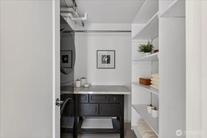 Dedicated utility room with laundry, counter space, and built-in shelving for additional storage.