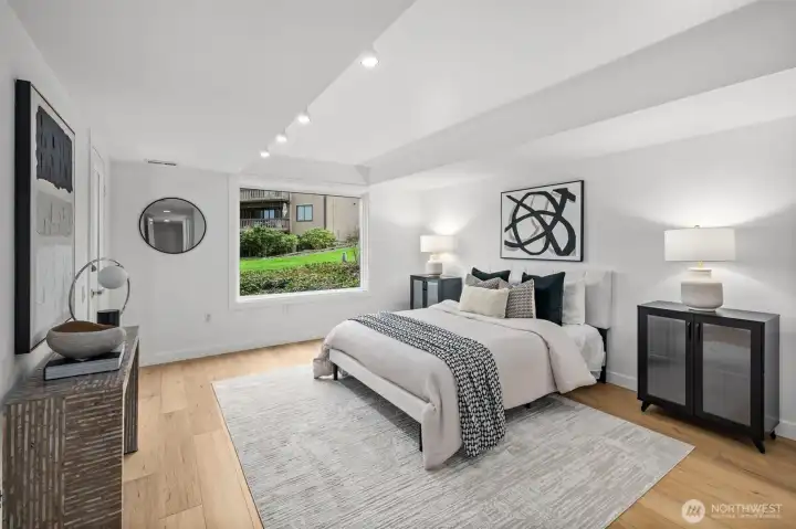 A spacious and luxurious primary suite, offering seamless patio access, stunning views, a generous walk-in closet, and a beautifully appointed attached bath.