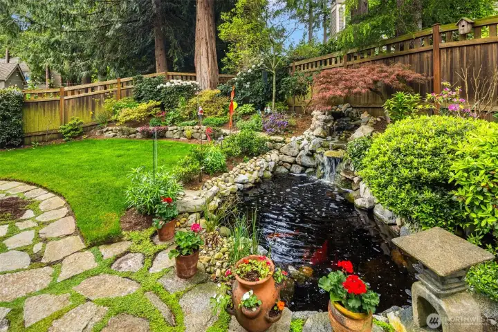 Lush and carefully designed landscaping with coy fish pond.