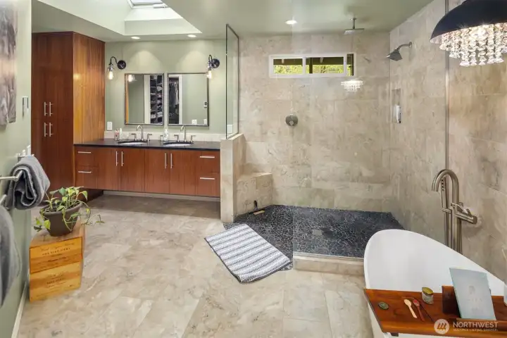 Spacious, spa-like primary bathroom with a modern, upscale design