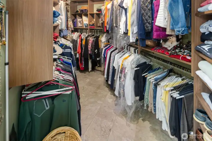 Well-organized primary walk-in closet designed for ample storage and easy accessibility.