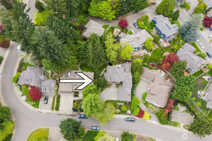 Home sits on a quiet, curved street and has a spacious driveway leading to the front entrance