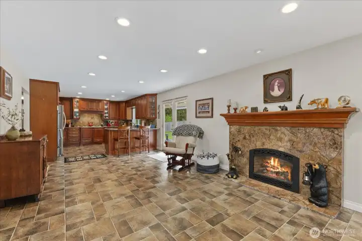 Kitchen and dining areas are anchored by a gas fireplace.