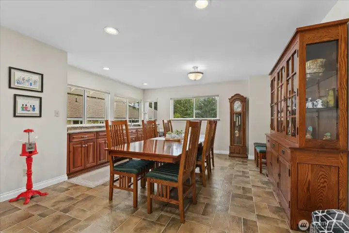 Spacious dining w/wet bar area seamlessly connects to the kitchen—ideal for hosting.