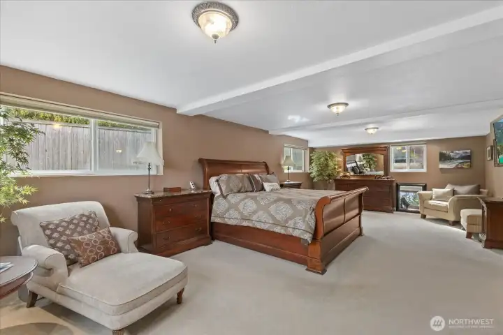 Generous lower-level primary suite with walk-in closet & private ¾ bath