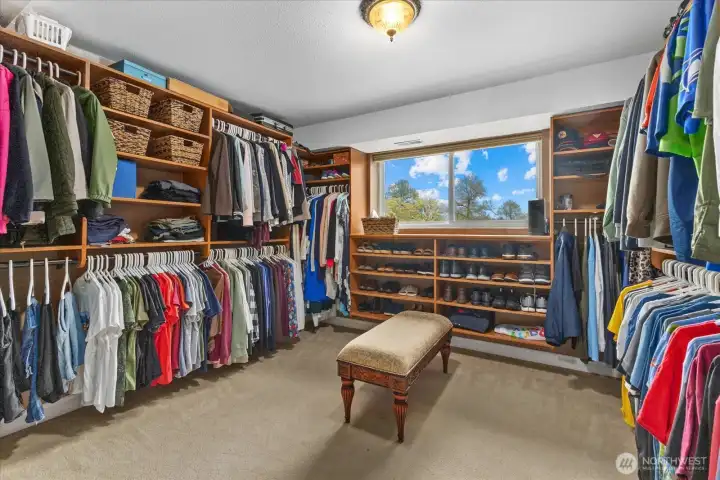 Spacious walk-in closet with room for everything in its place. Custom shelving by California Closets