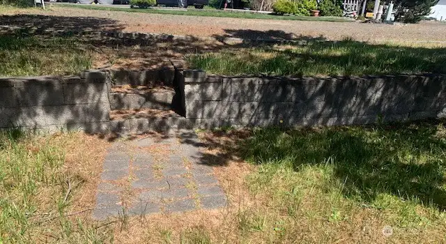 Stone steps leading down from the graveled parking area for the RV's.