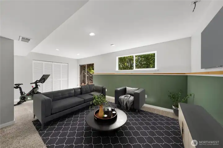 Downstairs staged as a rec room/ theater.