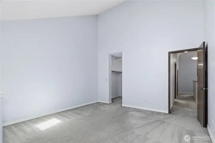Primary bedroom with vaulted ceiling and access to closet area and also main upstairs hallway. Primary bedroom with vaulted ceiling and access to closet area and also main upstairs hallway.
