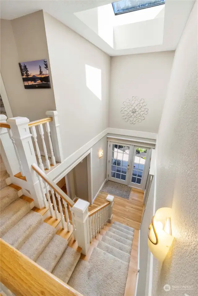 Light and bright entry with stairs leading to bedrooms and laundry up.