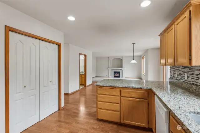 Big kitchen with large pantry (behind white double doors on the left), lovely granite countertops and tile backsplash. Open to eating area and  family room