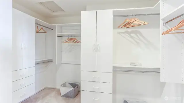 No shortage of space or storage in this massive primary walk-in closet equipped with closet system.