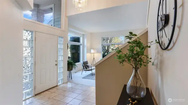 Enter to soaring ceilings and an entryway bathed in natural light with elegant glass accents on either side of the front door.