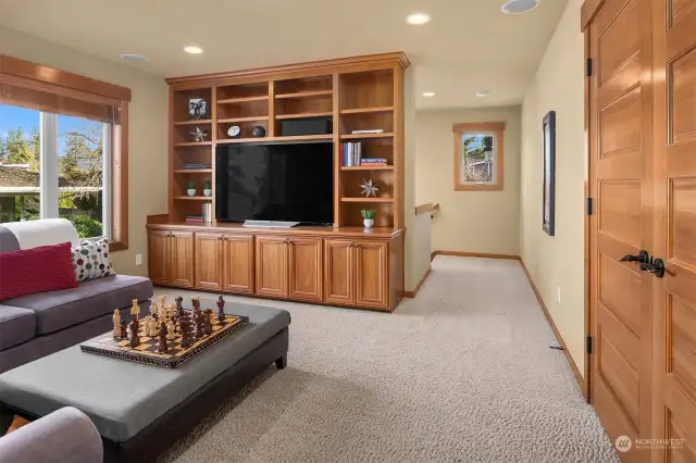 The upper-level bonus room features a wall of built-in cabinets and shelving, adding to the homes abundant storage space, and is equipped with surround sound speakers for movies, or to use as a game room or play room.  The Bonus room is accessible from a second staircase.