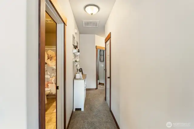 hall leading to full bath, storage, 2 bedrooms plus more!
