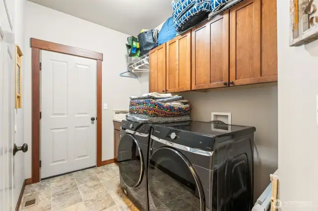 laundry room with storage, door to garage
