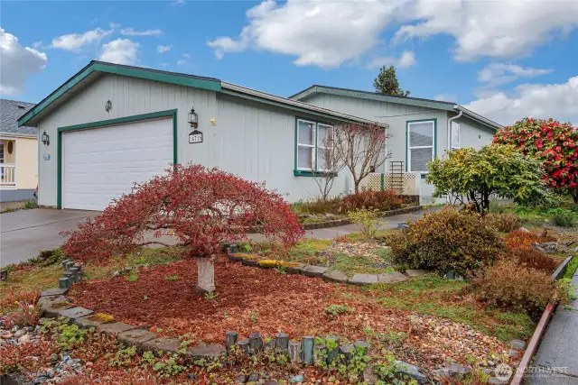 Welcome to Noble firs! Great floor plan tax records say 3 bedrooms but it is 2 bedrooms plus an office that could possibly be a 3rd bedroom, pretty landscaping, a good size two car garage that actually holds two cars inside! A covered walkway from the back of the garage to the home on the other side so you never need to carry your groceries in the rain! Tall vaulted ceilings throughout, skylights and large windows bring a ton of natural light in. Home includes a heat pump with a/c.
