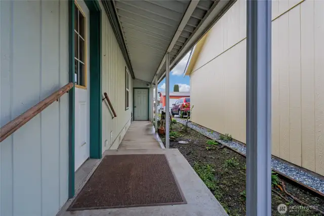 This is the covered walkway outside of the utility room to the garage. You never have to carry your groceries in the rain here. Pull into the garage and exit covered to the house!