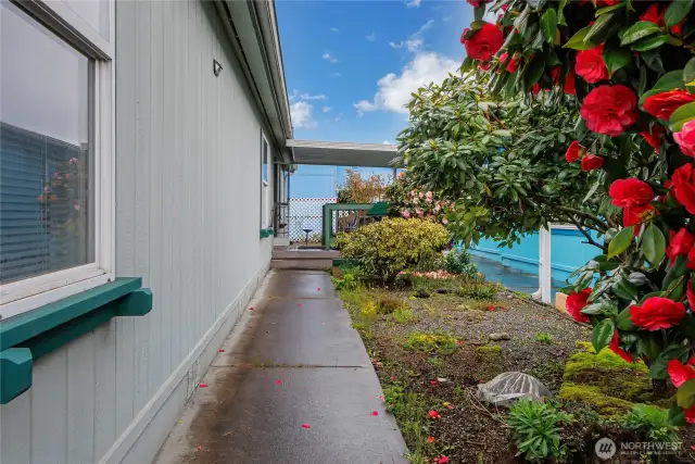 Landscaped walkway leads to the covered from porch entry.